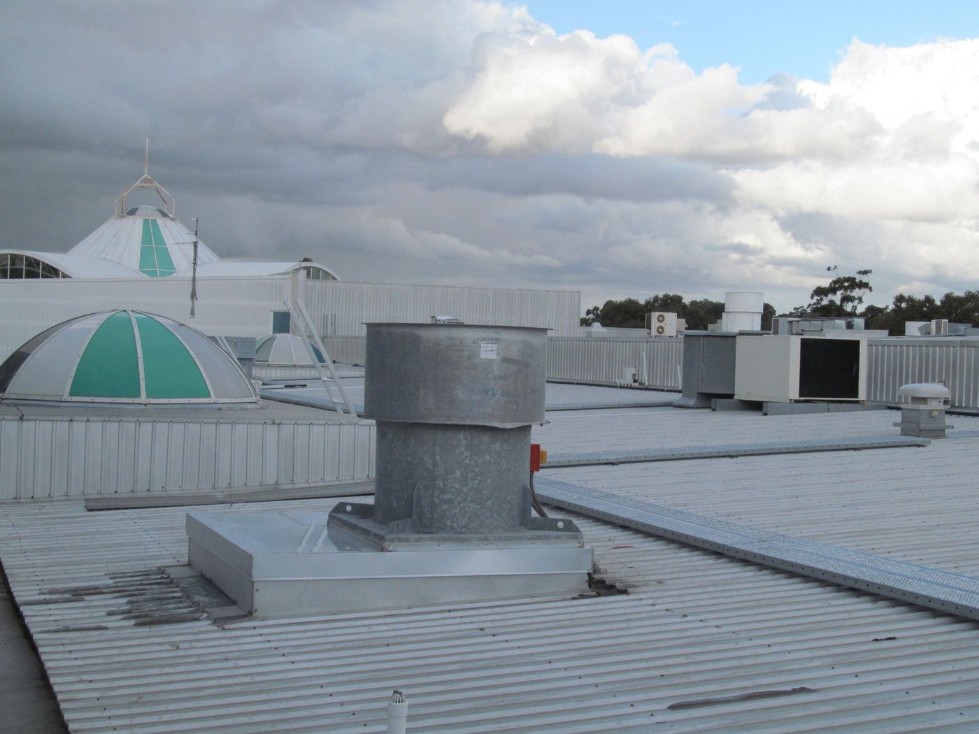 Air conditioning units and an exhaust fan on a shopping center roof