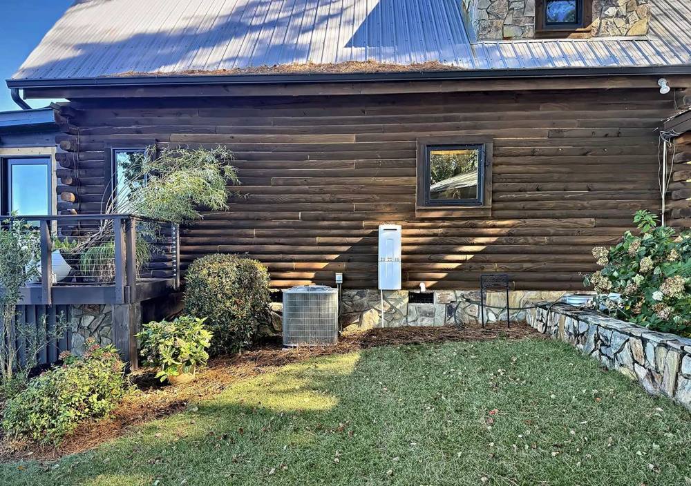 Central air condenser we installed beside a log home