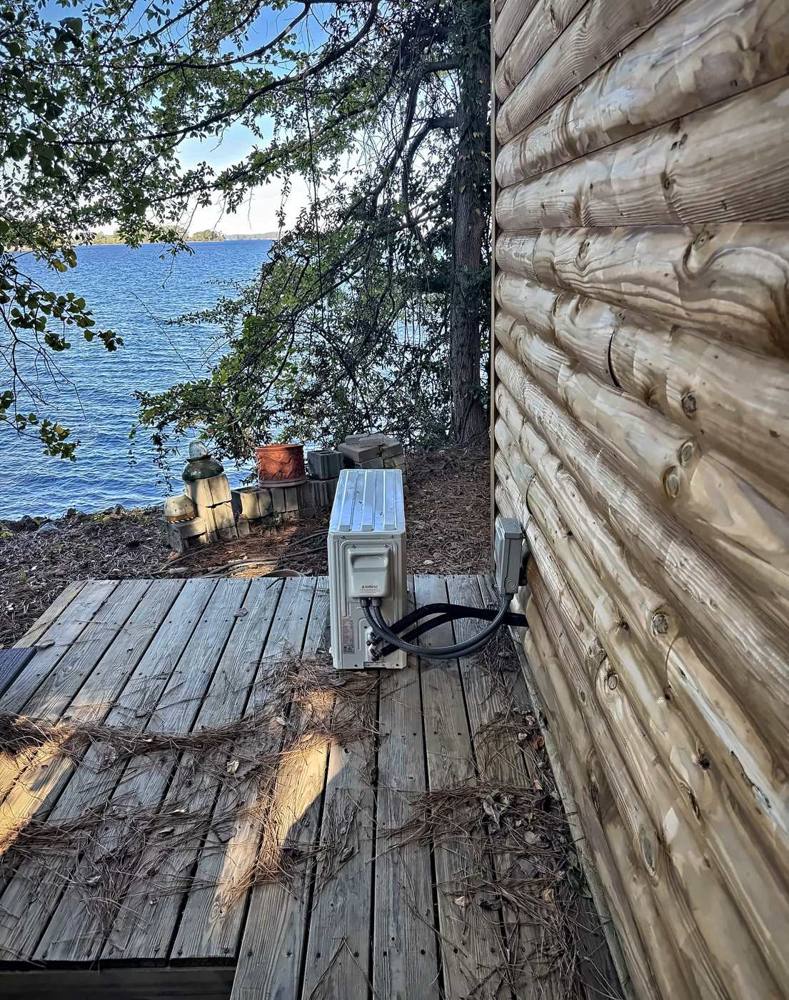 Mini split outdoor unit with line set on a deck overlooking Lake Murray
